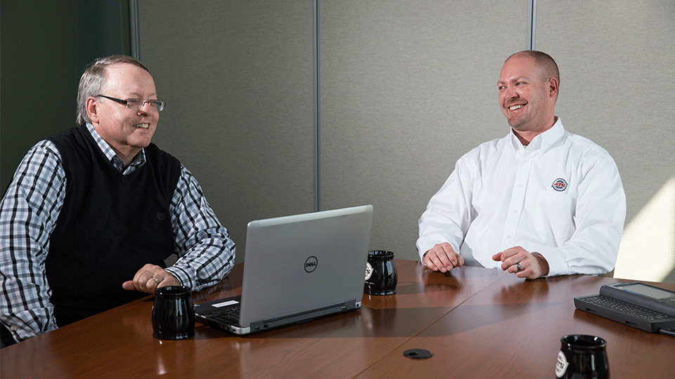Two permit coordinators at table